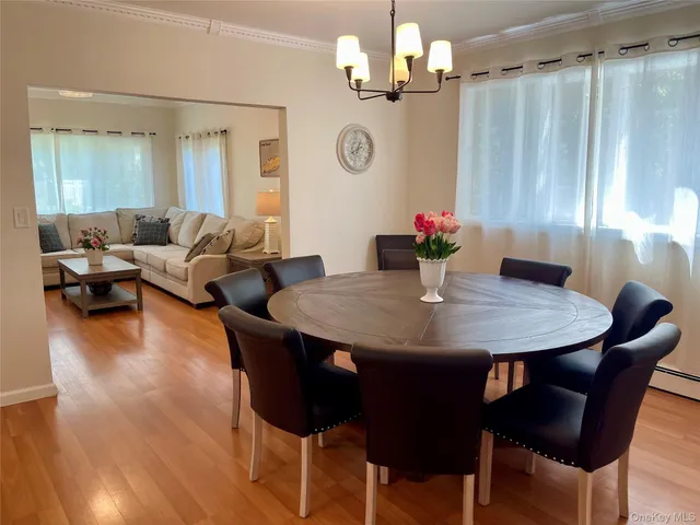 a view of a dining room with furniture wooden floor and chandelier