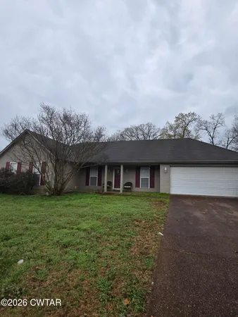 a view of a big house with a big yard and large tree