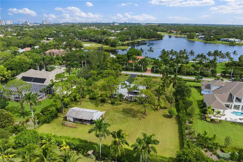 124 Eugenia Drive Naples, FL 34108 - Photo 11 of 20 an aerial view of residential houses with outdoor space and lake view