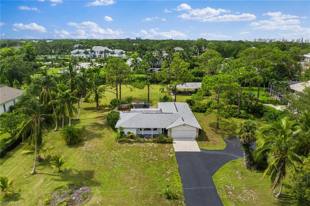 124 Eugenia Drive Naples, FL 34108 - Photo 19 of 20 a view of a garden with an outdoor space