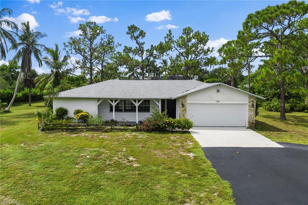 124 Eugenia Drive Naples, FL 34108 - Photo 20 of 20 a front view of a house with garden