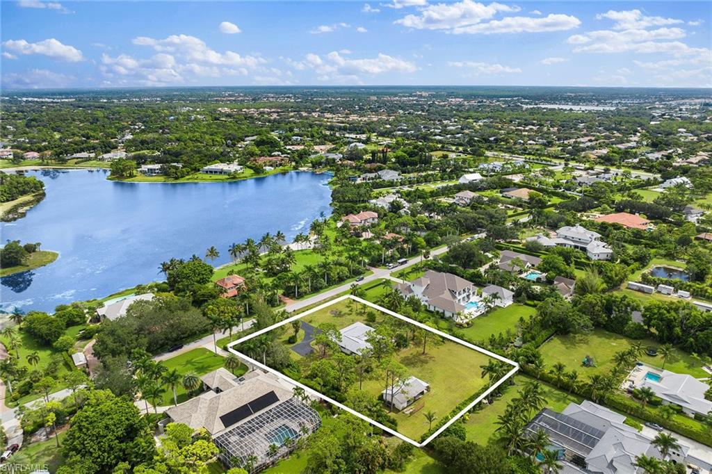 124 Eugenia Drive Naples, FL 34108 - Photo 3 of 20 an aerial view of residential houses with outdoor space and lake view