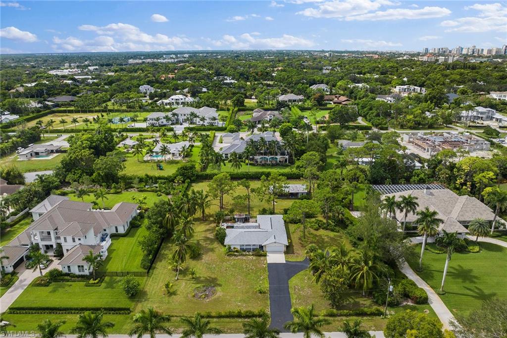 124 Eugenia Drive Naples, FL 34108 - Photo 5 of 20 an aerial view of residential houses with outdoor space and trees