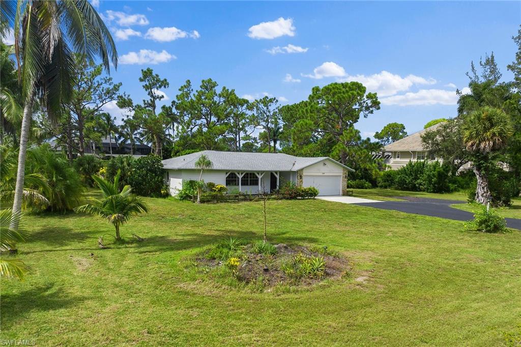 124 Eugenia Drive Naples, FL 34108 - Photo 6 of 20 a view of a house with a yard