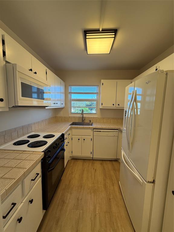 Undisclosed Address Fort Lauderdale, FL 33308 - Photo 11 of 28 a kitchen with white cabinets and white appliances