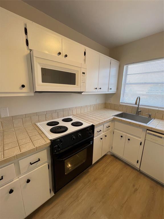 Undisclosed Address Fort Lauderdale, FL 33308 - Photo 7 of 28 a kitchen with granite countertop white cabinets and white appliances