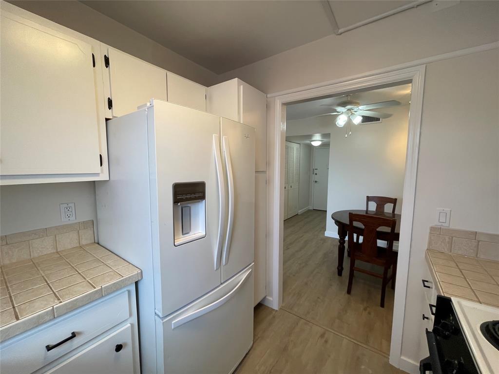 Undisclosed Address Fort Lauderdale, FL 33308 - Photo 8 of 28 a kitchen with a refrigerator and table chairs