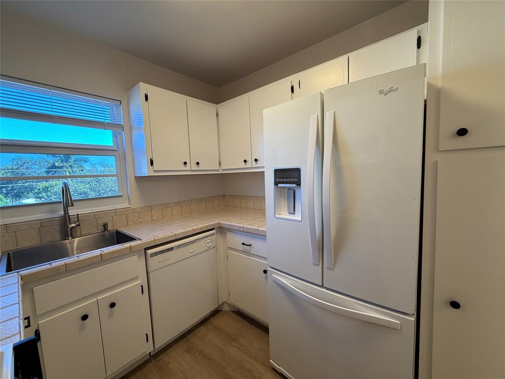 Undisclosed Address Fort Lauderdale, FL 33308 - Photo 10 of 28 a white refrigerator freezer sitting inside of a kitchen