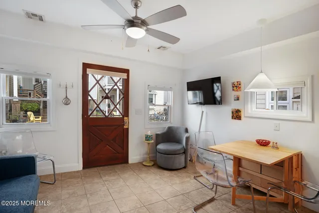 a living room with furniture and a chandelier
