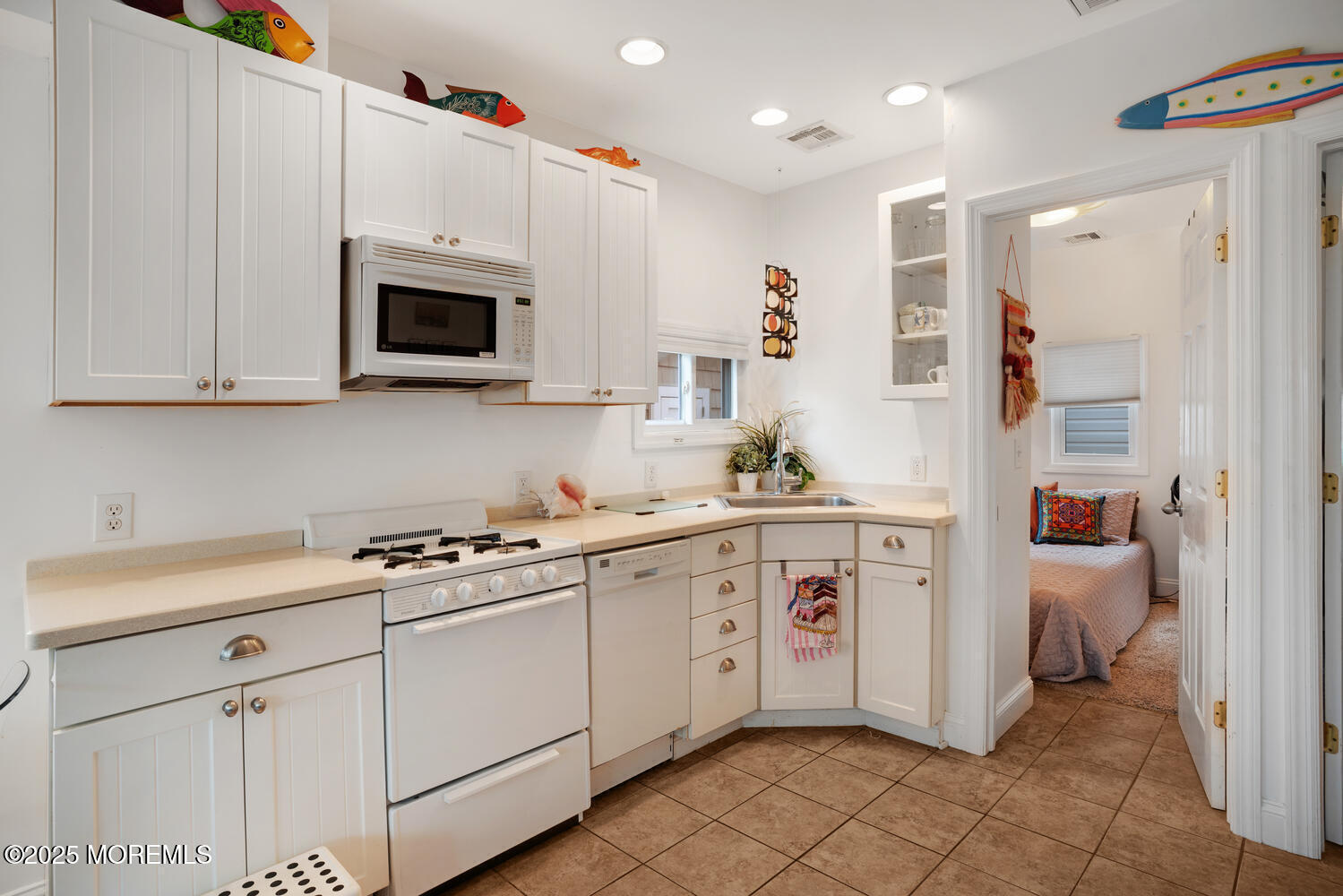 34 West Rutherford Lane Lavallette, NJ 08735 - Photo 13 of 27 a kitchen with white cabinets and white appliances