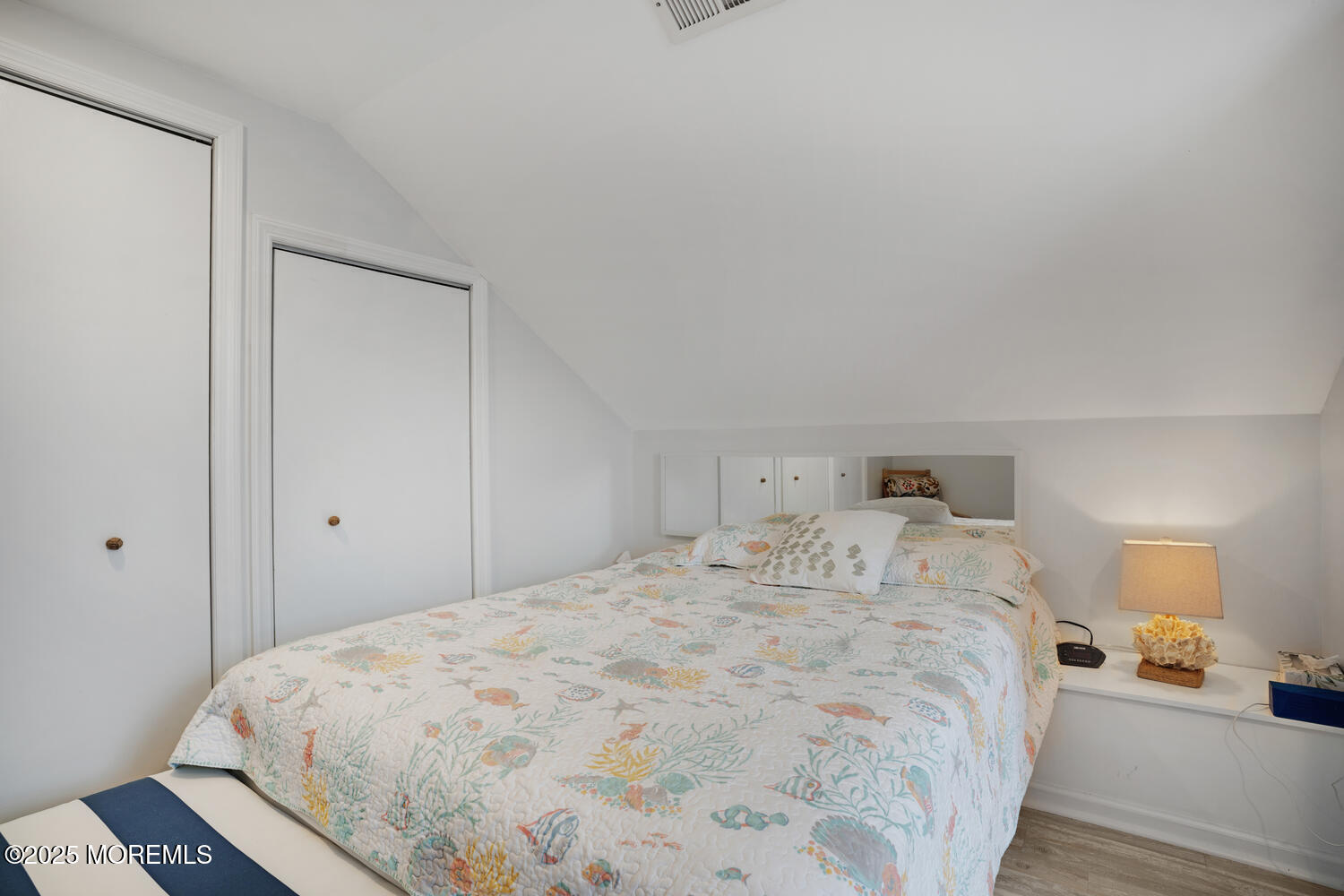 34 West Rutherford Lane Lavallette, NJ 08735 - Photo 23 of 27 a bedroom with a bed and a lamp on dresser