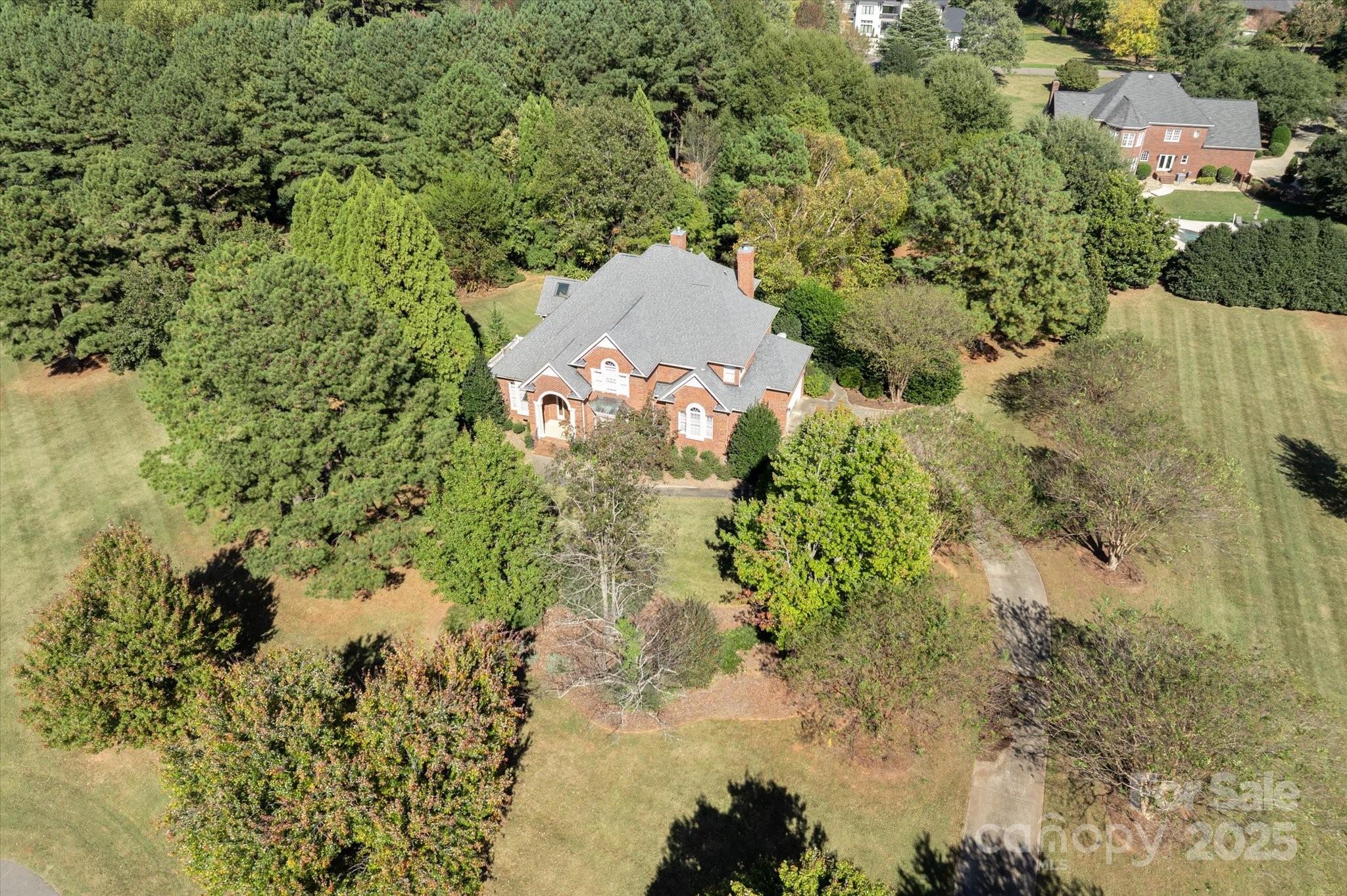 405 Valley Run Road Waxhaw, NC 28173 - Photo 8 of 9 a aerial view of a house with a yard and large trees all around