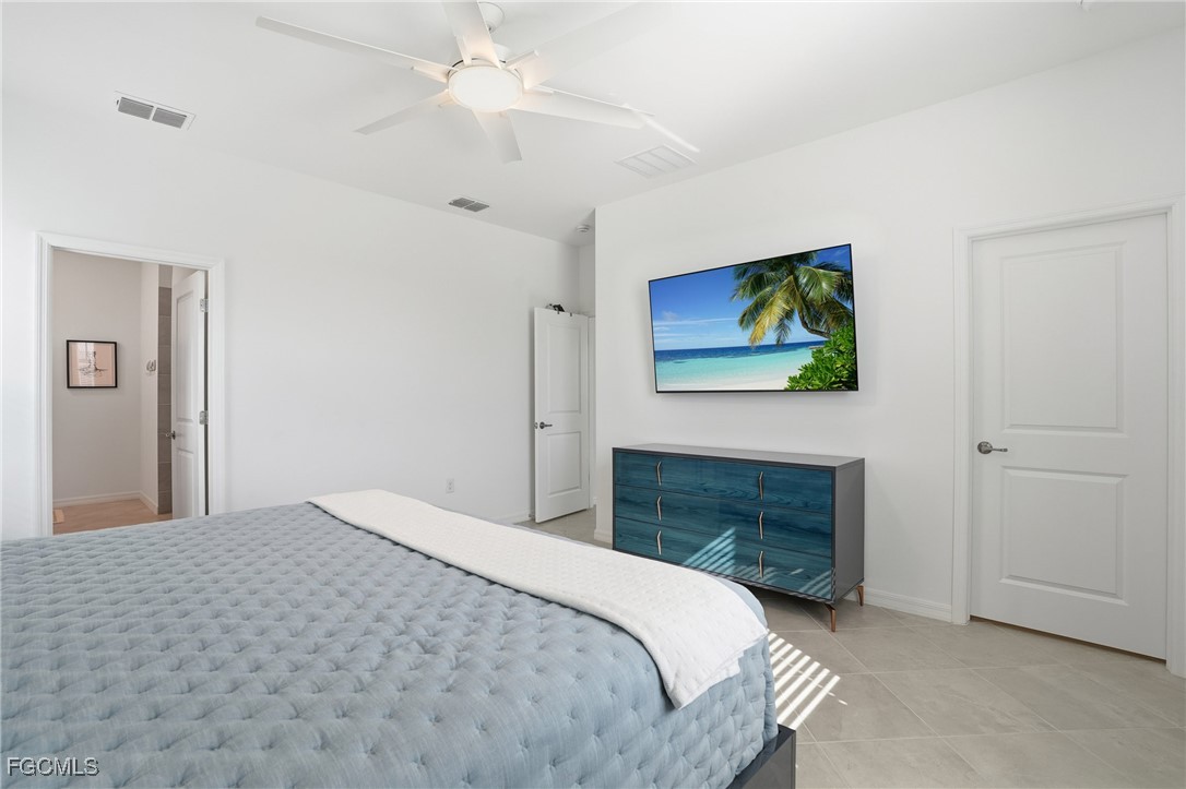 2662 Scarlet Way Naples, FL 34120 - Photo 11 of 47 a bedroom with a bed and a fireplace