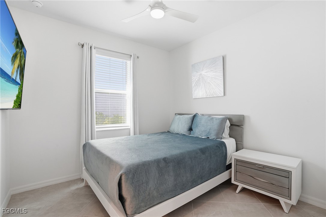 2662 Scarlet Way Naples, FL 34120 - Photo 15 of 47 a bedroom with a bed and a window