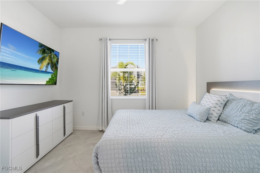 2662 Scarlet Way Naples, FL 34120 - Photo 16 of 47 a bedroom with a bed and a window