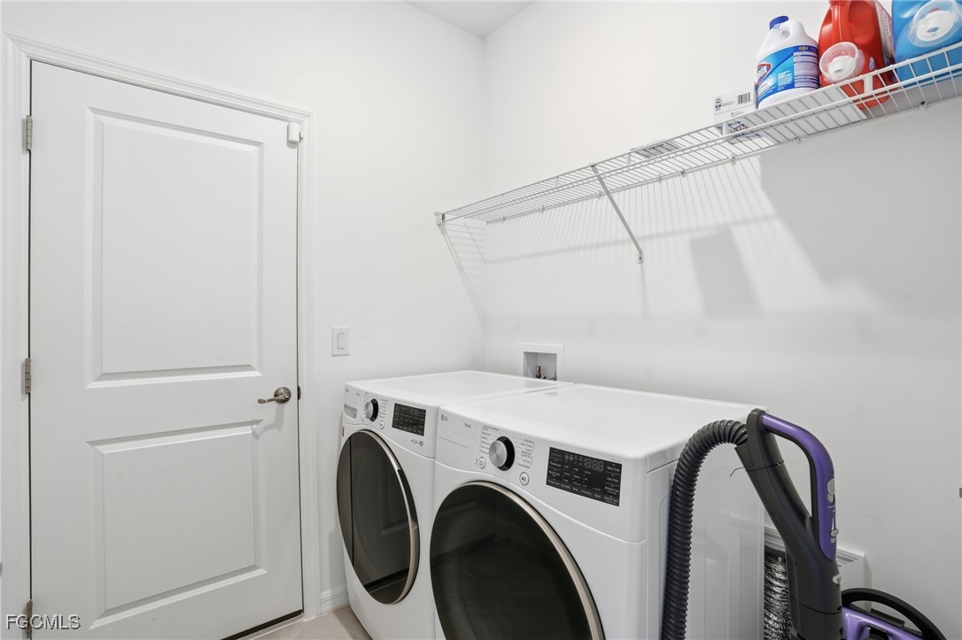 2662 Scarlet Way Naples, FL 34120 - Photo 19 of 47 a utility room with dryer and washer