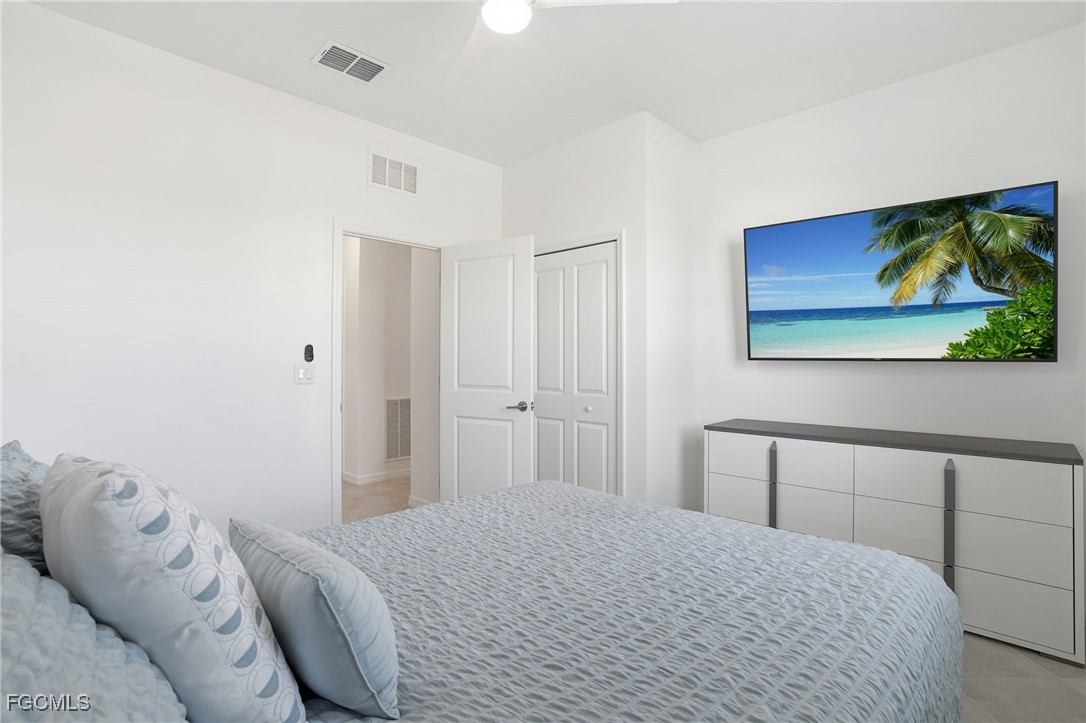 2662 Scarlet Way Naples, FL 34120 - Photo 20 of 47 a bedroom with a bed and a painting on the wall