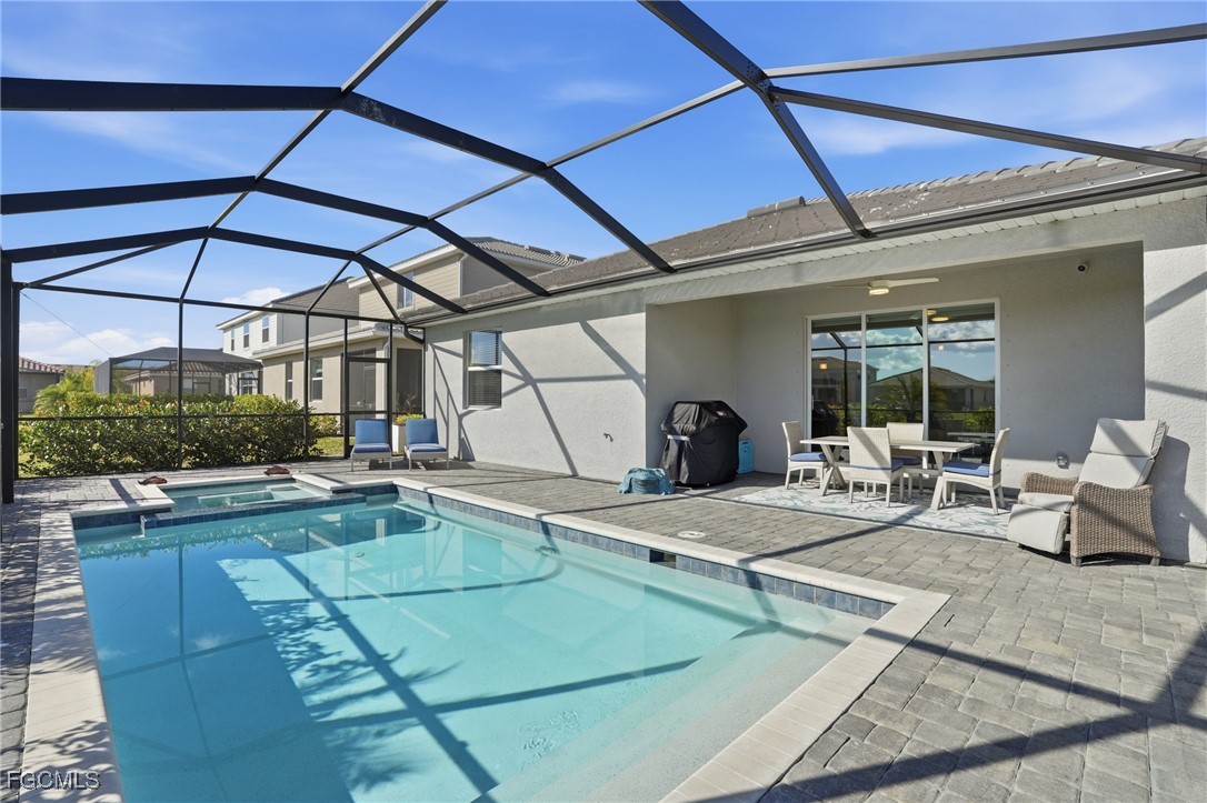 2662 Scarlet Way Naples, FL 34120 - Photo 27 of 47 a view of a patio with swimming pool table and chairs