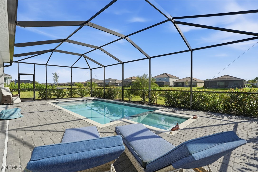 2662 Scarlet Way Naples, FL 34120 - Photo 28 of 47 a view of a patio with a table and chairs