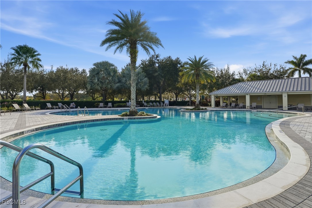 2662 Scarlet Way Naples, FL 34120 - Photo 31 of 47 a view of a swimming pool with a garden