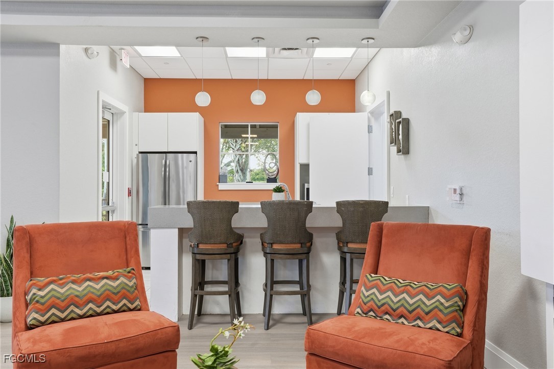 2662 Scarlet Way Naples, FL 34120 - Photo 40 of 47 a outdoor living space with furniture and a large window