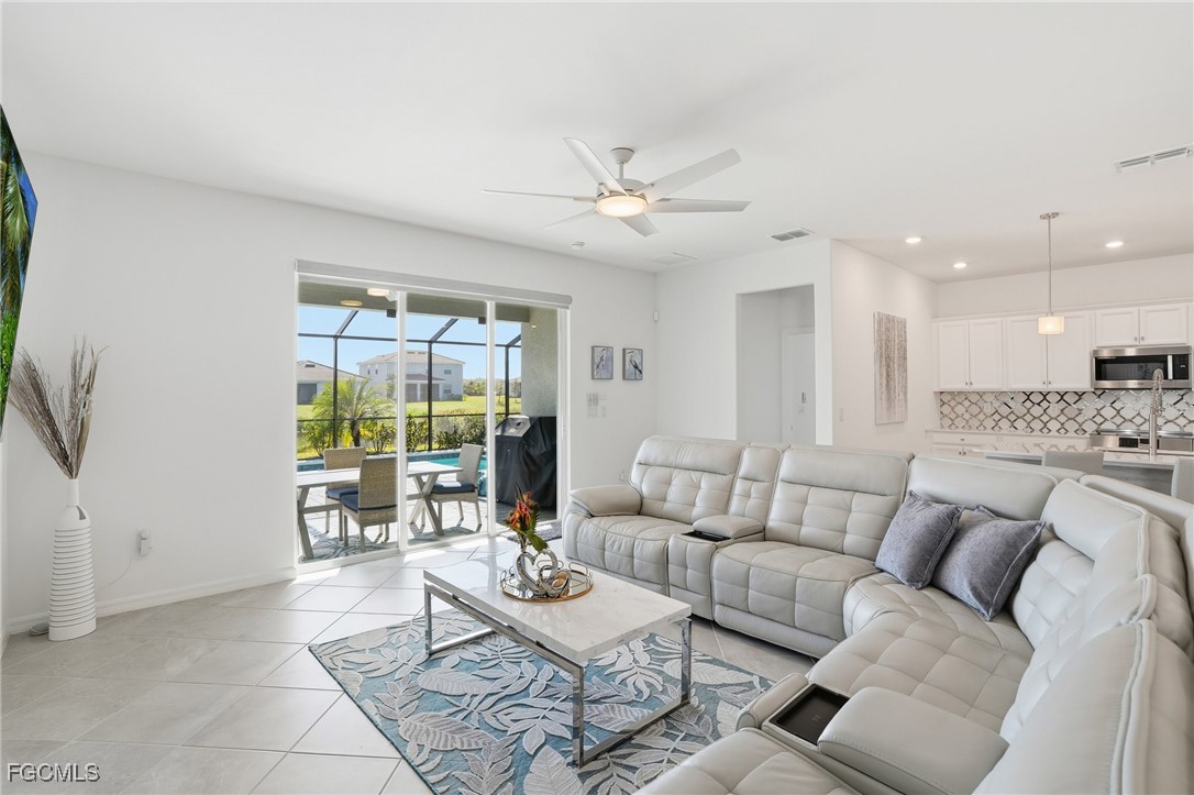 2662 Scarlet Way Naples, FL 34120 - Photo 8 of 47 a living room with furniture and a large window