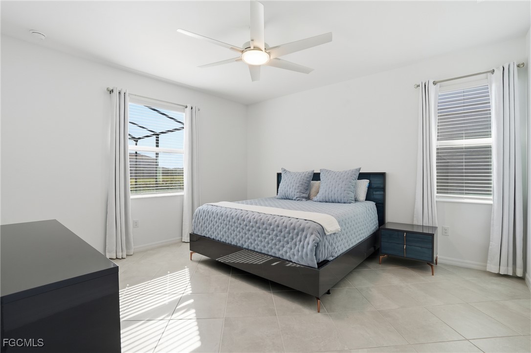 2662 Scarlet Way Naples, FL 34120 - Photo 9 of 47 a spacious bedroom with a bed and a window