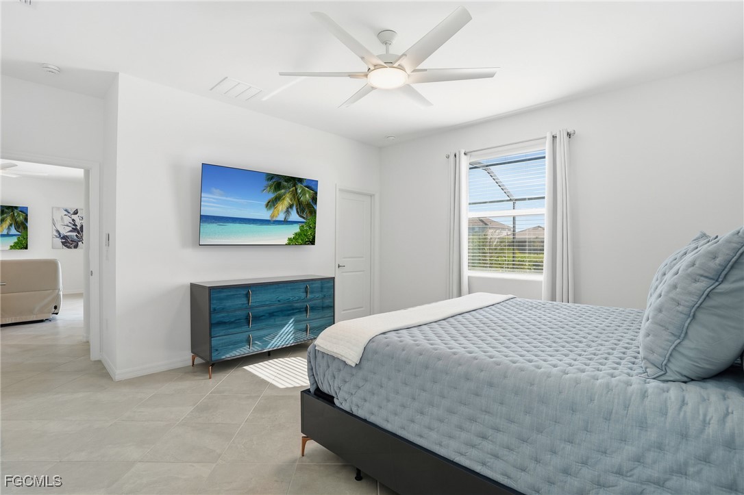 2662 Scarlet Way Naples, FL 34120 - Photo 10 of 47 a bedroom with a bed dresser and a window