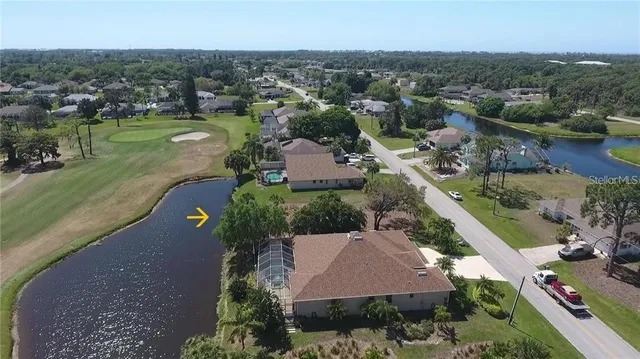 an aerial view of residential houses with outdoor space and river