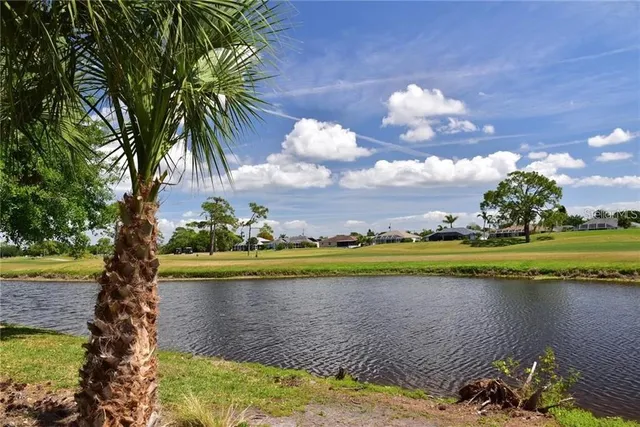 a view of a lake with a house in the background