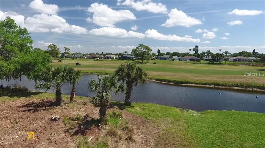 232 Rotonda Circle Rotonda West, FL 33947 - Photo 4 of 5 a view of a lake with a yard