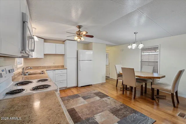 a view of a dining room with furniture and chandelier