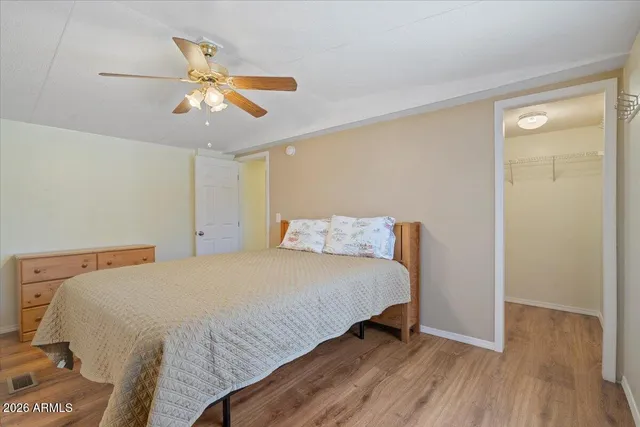 a bedroom with a bed and wooden floor