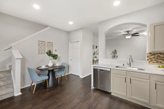 a view of a kitchen area with furniture and wooden floor