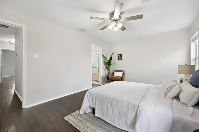 a bedroom with a bed and wooden floor