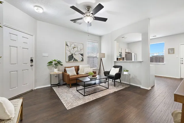 a living room with furniture and wooden floor