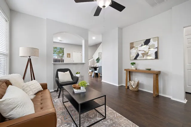 a living room with furniture and a wooden floor