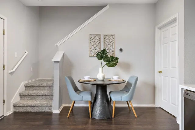 a view of a dining room with furniture and wooden floor