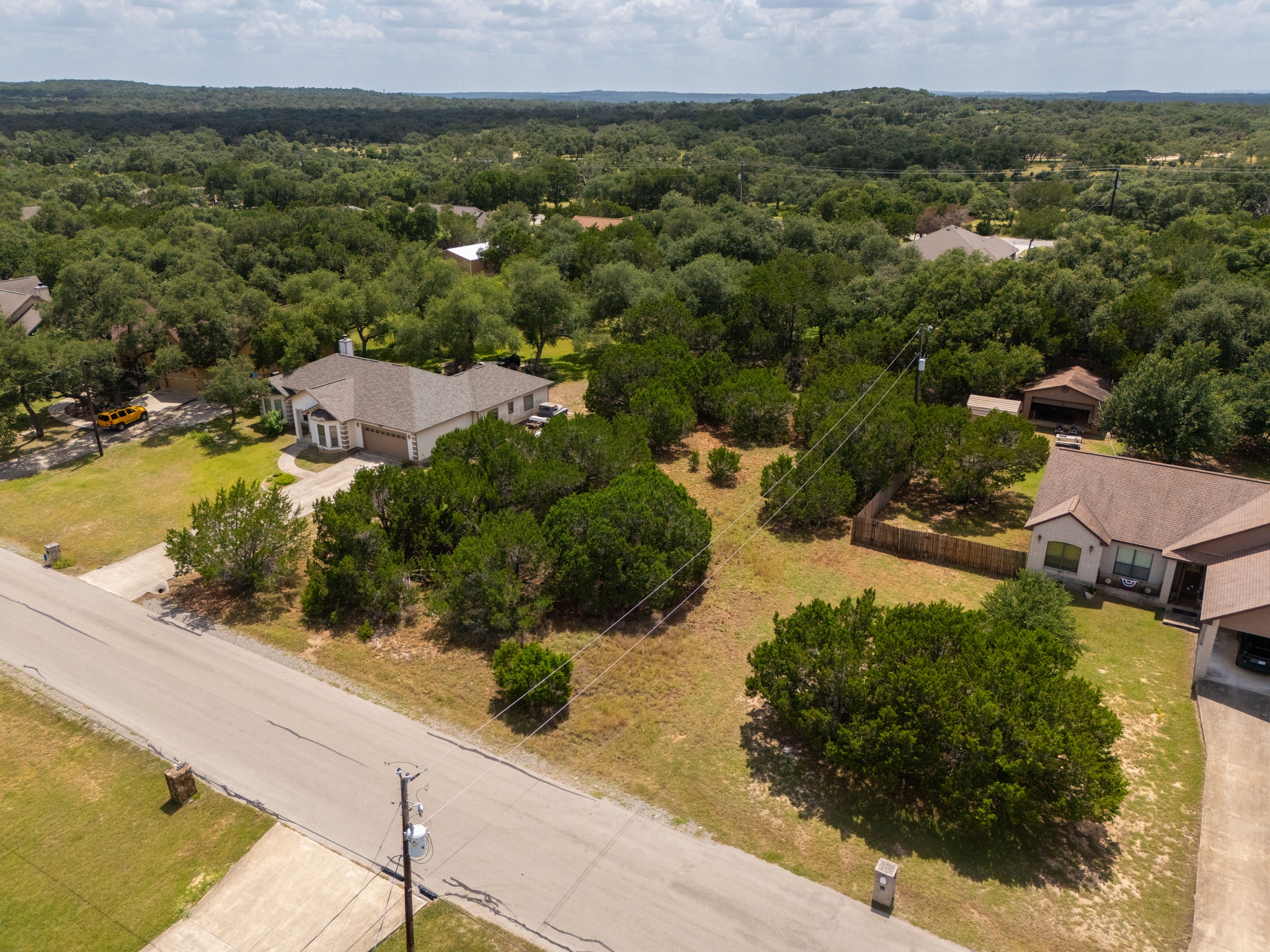 1170 Misty Lane Spring Branch, TX 78070 - Photo 9 of 24 Aerial perspectives reveal a tranquil neighborhood nestled amidst a lush, wooded landscape.