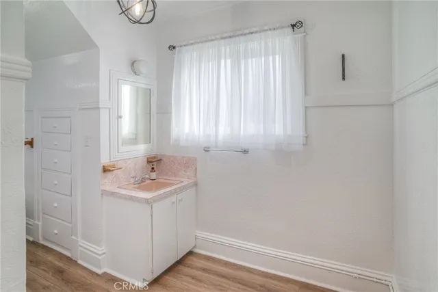 an empty room with a ceiling fan and a bathroom