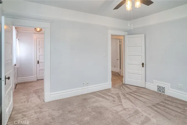 a view of a house with a small yard and sitting area