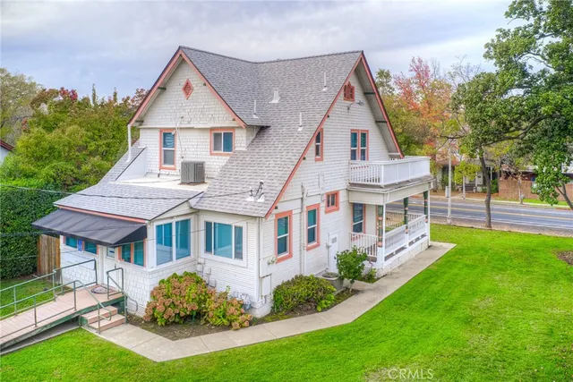 a aerial view of a house with a yard table and chairs