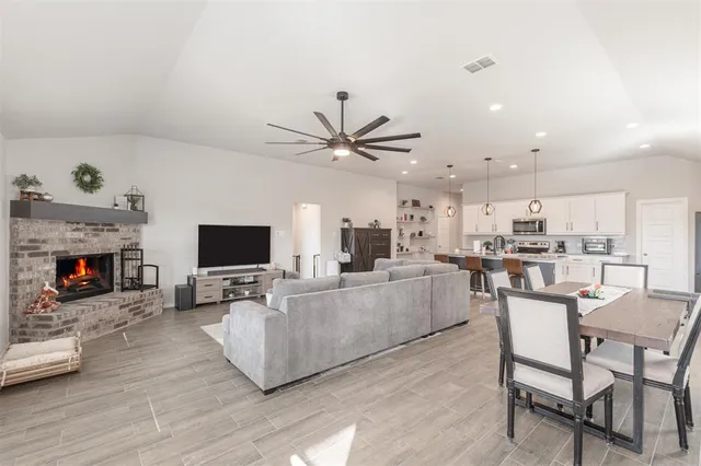 a living room with furniture a fireplace and a flat screen tv
