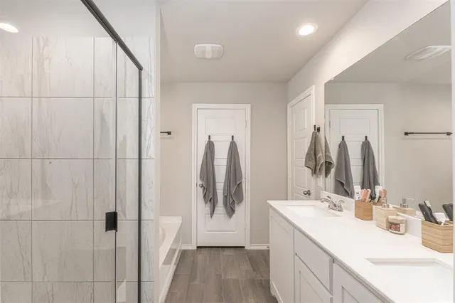 a bathroom with a double vanity sink and mirror
