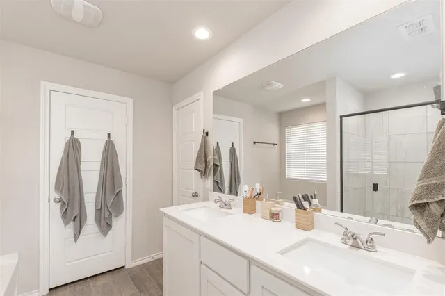 a bathroom with a double vanity sink and a mirror