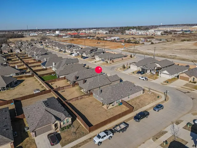 an aerial view of residential houses with outdoor space