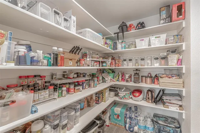 a kitchen with stainless steel appliances granite countertop a sink and a refrigerator
