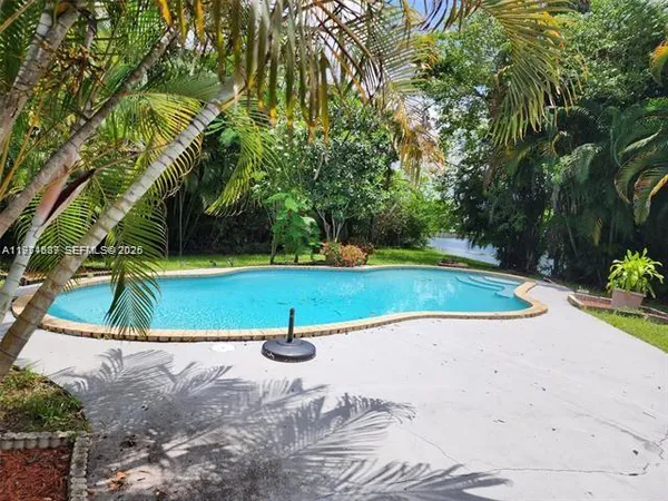 a view of a swimming pool with a yard