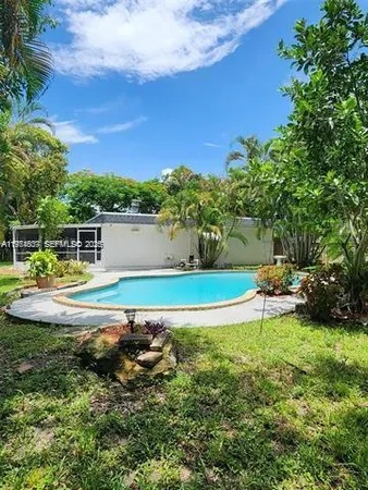 a view of a swimming pool with a yard