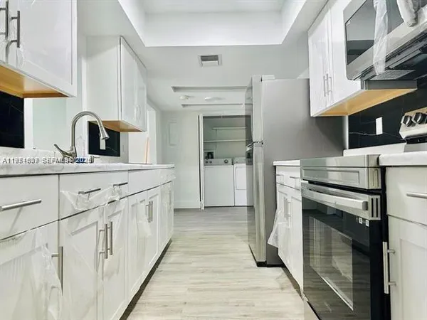 a kitchen with a sink and a stove top oven